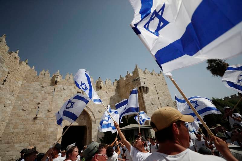 Israeli flags are carried during the right-wing 'flag march' next to the Damascus Gate in Jerusalem's Old City. EPA