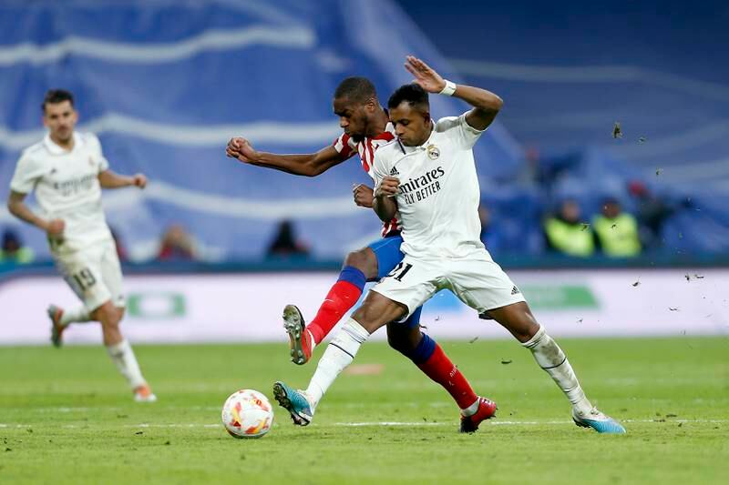 Geoffrey Kondogbia of Atletico Madrid competes for the ball with Rodrygo. Getty Images