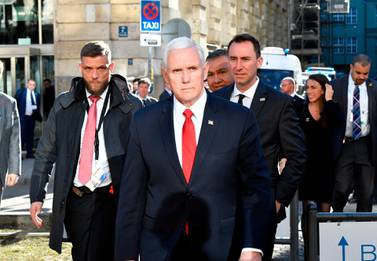 US Vice President Mike Pence crosses a street to give a statement in front of the Bayerischer Hof hotel at the 55th Munich Security Conference in Munich. AFP