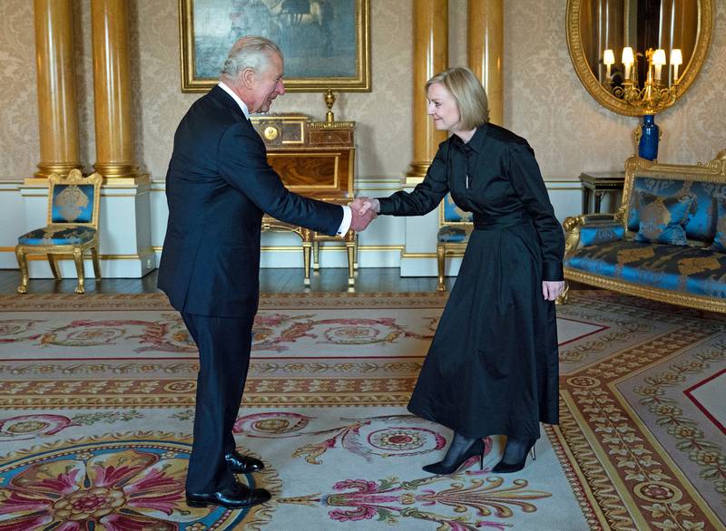 The king greets then-prime minister Liz Truss at Buckingham Palace. AFP