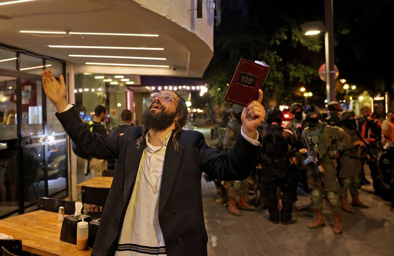 An ultra-Orthodox Jewish man reacts outside the scene of the shooting. AFP