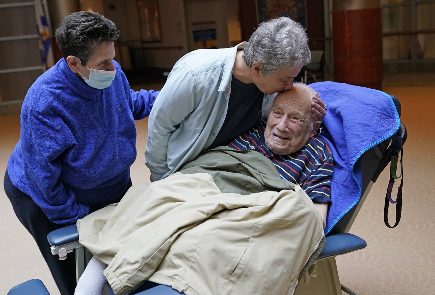 Melvin Goldstein, 90, smiles as his daughter Barbara Goldstein greets him in their first in-person, indoor family visit inside the Hebrew Home at Riverdale, March 28, 2021, in the Bronx borough of New York. AP