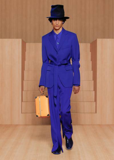 The new collection for spring / summer 2022 from Louis Vuitton offers a blast of colour, such as this mid-blue suit, tied with a matching belt. Courtesy Louis Vuitton