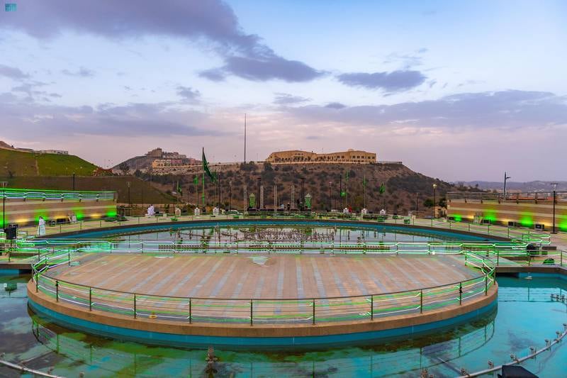 Al Baha adorned with national flags and pictures of the leadership and covered in green to celebrate the 91st National Day.
