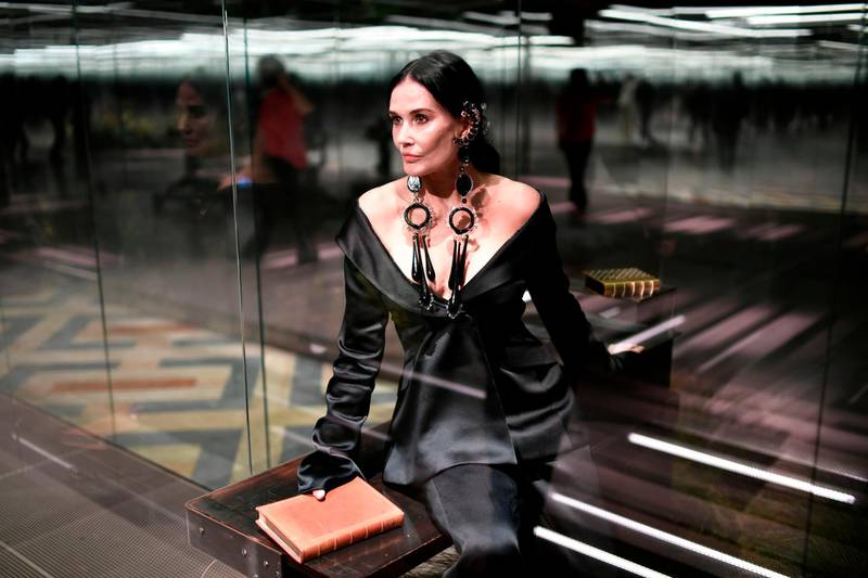Demi Moore poses in her glass box on the Fendi runway. AFP