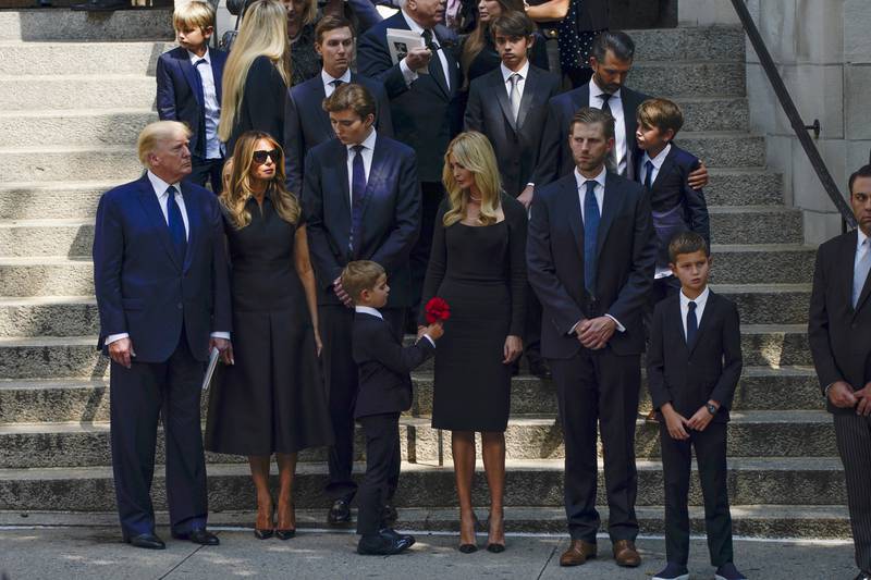 Former US president Donald Trump stands with his family, after the funeral of his former wife Ivana Trump, at St Vincent Ferrer church in New York.  AP