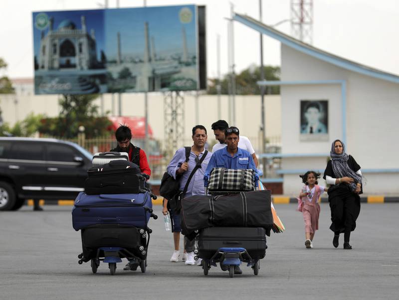 People head to the departures area of Hamid Karzai International Airport in Kabul as the Taliban approach the city.