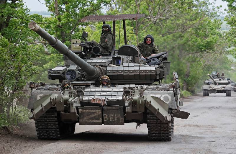Pro-Russian troops drive a tank in Ukraine's Donetsk region. Reuters