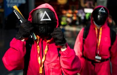 Sebastian Buria, left, and Percey Robles, right, of New Jersey, cosplay as the guards from 'Squid Game'. EPA