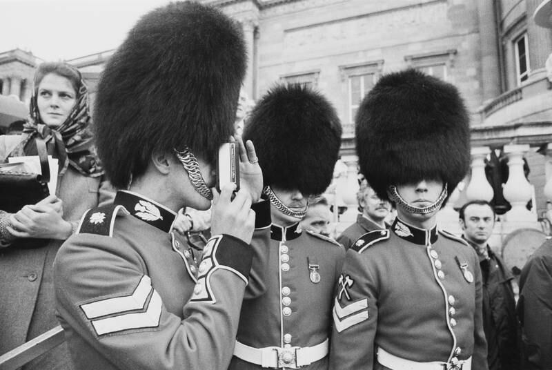 A Scots Guard takes a picture during the silver jubilee celebrations at Buckingham Palace. 