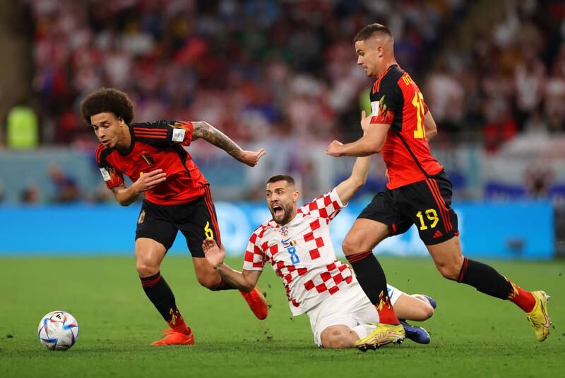 Mateo Kovacic of Croatia is challenged by Axel Witsel and Leander Dendoncker of Belgium. Getty