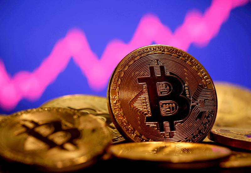 FILE PHOTO: A representation of virtual currency Bitcoin is seen in front of a stock graph in this illustration taken January 8, 2021. REUTERS/Dado Ruvic/File Photo/File Photo