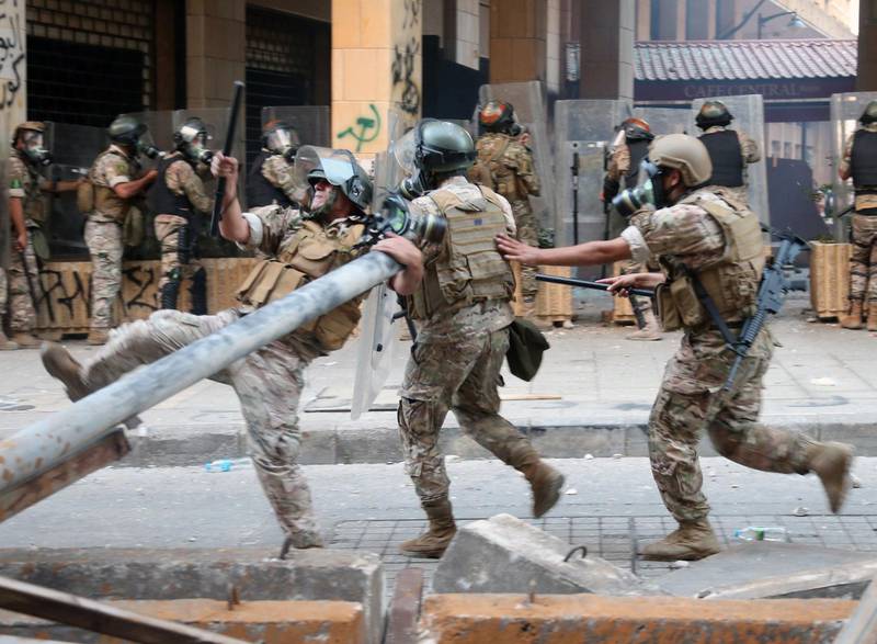 Lebanese security forces run during clashes with anti-government protesters. EPA