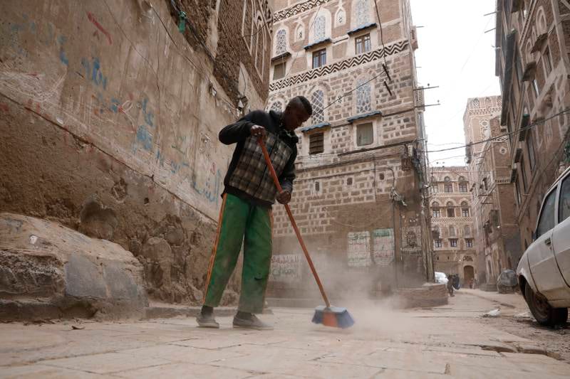 A worker cleans up a street before Eid Al Fitr in the old city of Sanaa, Yemen. EPA