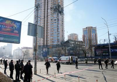 Emergency services workers near an apartment building damaged by shelling in Kiev. Reuters