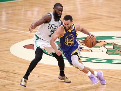 Stephen Curry dribbles past Jaylen Brown. USA TODAY Sports