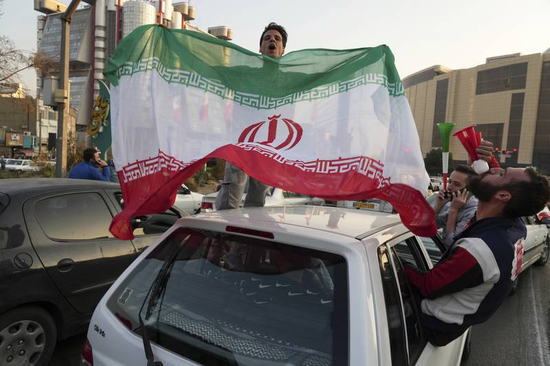 People celebrate after Iran's World Cup win over Wales. The political turmoil that followed the death of Mahsa Amini in police custody has cast a shadow over Iran's matches at the World Cup and global energy supplies.AP