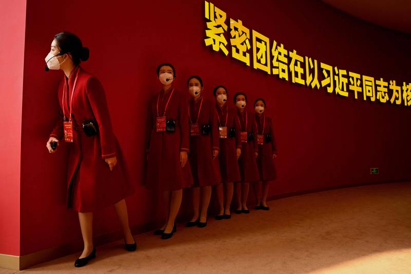 Attendants wait for visitors to an exhibition entitled 'Forging Ahead in the New Era', showing the country's achievements during Xi Jinping's two terms, at the Beijing Exhibition Centre before the 20th Communist Party Congress meeting. AFP