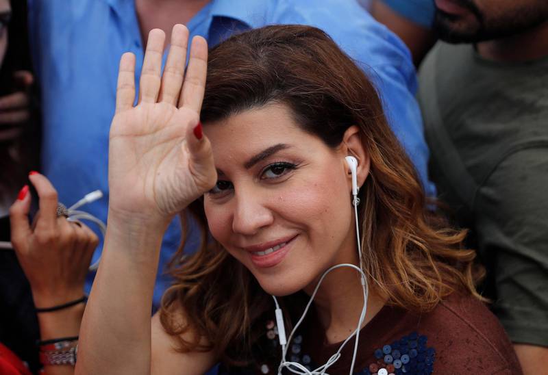 Paula Yacoubian, a journalist and candidate, waves as she attends a protest against the unofficial election results. Hussein Malla / AP Photo
