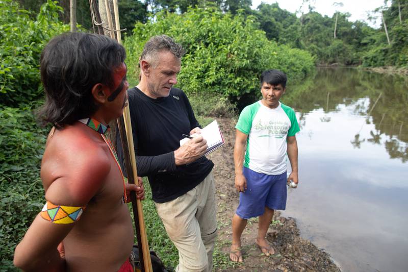 Veteran foreign correspondent Dom Phillips, centre, in Aldeia Maloca Papiú, in Roraima state, Brazil.  AFP