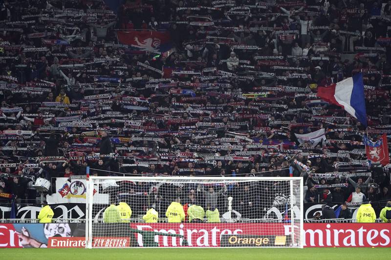 Lyon's supporters wave their flags after players left the field after Marseille's Dimitri Payet was injured by an object thrown by a Lyon supporter. AP Photo