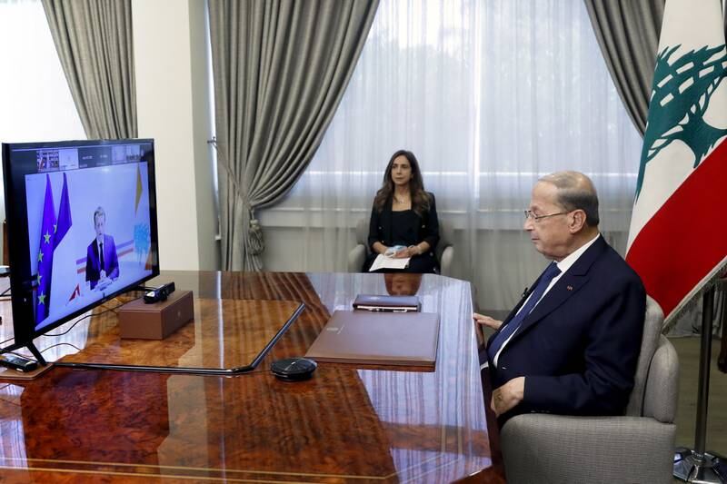 France's President Emmanuel Macron talks to his Lebanese counterpart Michel Aoun during a remote international conference to raise aid for the country. France has pledged about €100 million ($118.3m) in emergency aid as well as 500,000 Covid-19 vaccine doses for Lebanon.