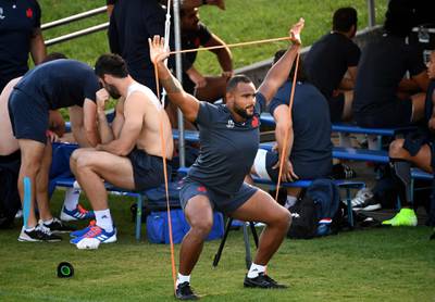 France's loose head prop Jefferson Poirot stretches before a training session. AFP