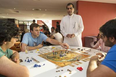 Members of Tabletop Café, a community of board-game enthusiasts, play a game during one of the group’s twice-weekly meetups at Gloria Hotel in Dubai Internet City. Antonie Robertson / The National