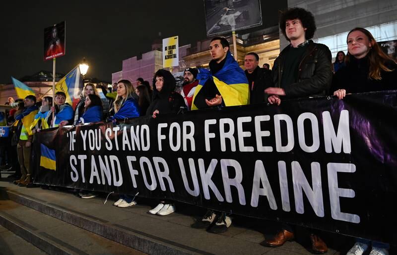 Ukrainians display a banner during the vigil in Trafalgar Square. EPA