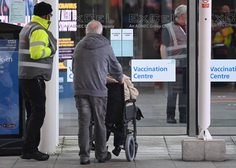 A couple arrive at a Covid-19 vaccination centre at the ExCel London. AFP