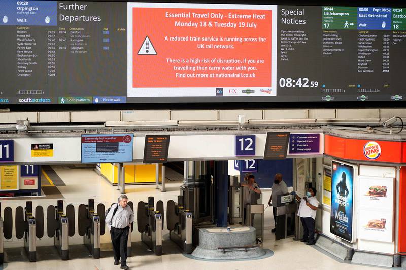 Message boards at London's Victoria Station warn passengers of potential disruption to train services due to the extreme heat. AFP