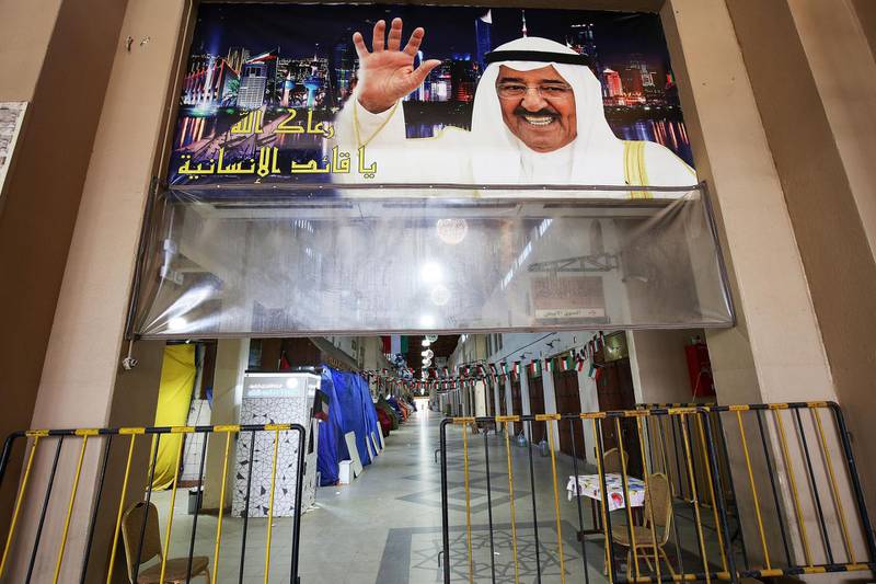A poster of Kuwait's emir Sheikh Sabah Al Ahmad Al Sabah is seen hanging above a closed entrance of the Mubarakiya market in Kuwait City during the 20-day nationwide lockdown. AFP