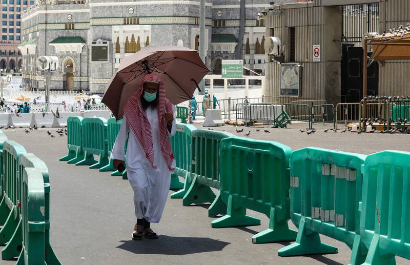 A man carries an umbrella to protect himself from the sun in Makkah. AFP