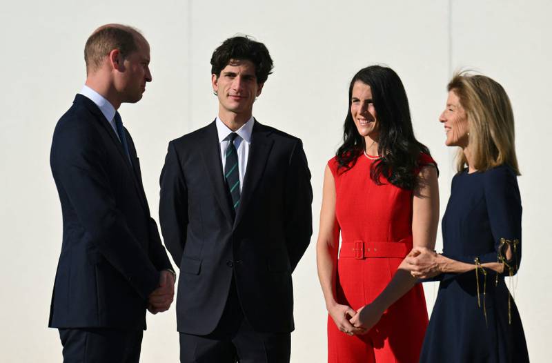 Prince William speaks with Jack and Tatiana Kennedy Schlossberg, the ambassador's children. AFP