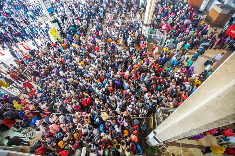 People wait to buy train tickets before the holiday at Kamalapur  station in Dhaka, Bangladesh. EPA