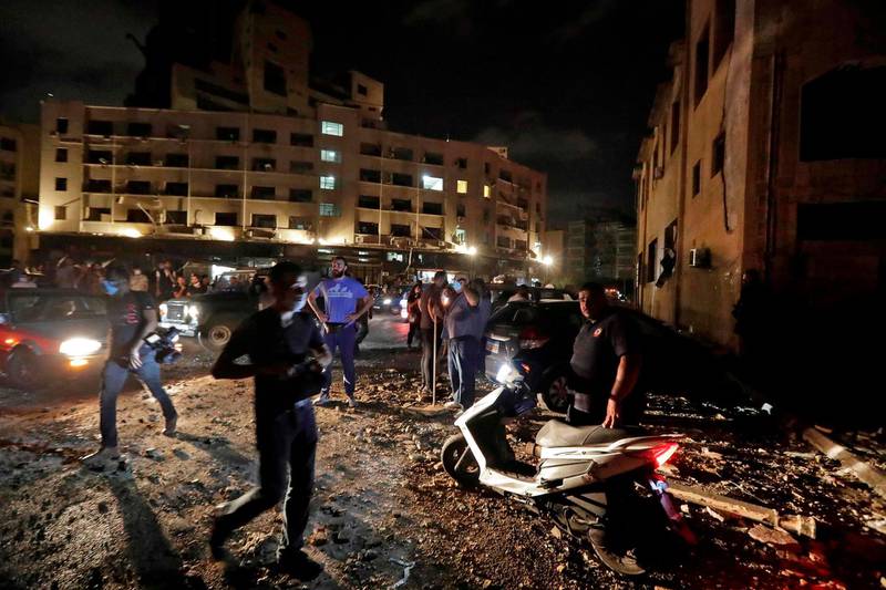 People and journalists gather at the scene of an explosion at the port of Lebanon's capital Beirut. AFP
