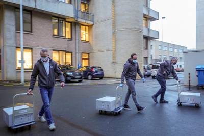 Staff pull boxes of Pfizer-BioNTech Covid-19 vaccines to be delivered to several care homes in Leuven, Belgium. AFP