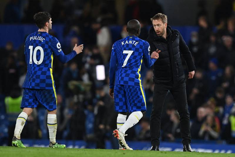 Brighton manager Graham Potter shakes hands with Chelsea midfielder N'Golo Kante after the Premier League match on December 29, 2021. AFP