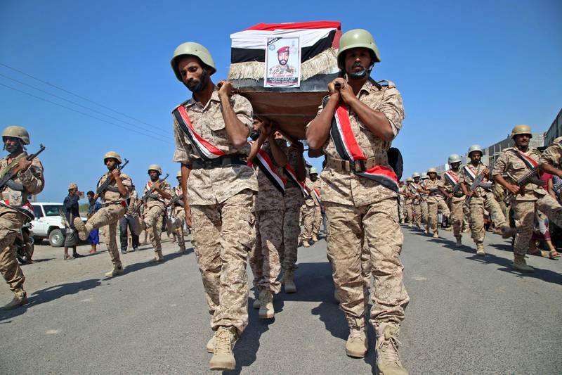 Fighters loyal to Yemen's Saudi-backed government march during a mass funeral for fellow combatants. AFP