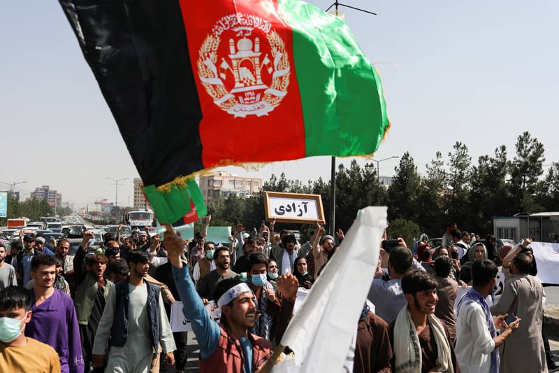 A man waves the flag of the former Afghan government. Reuters