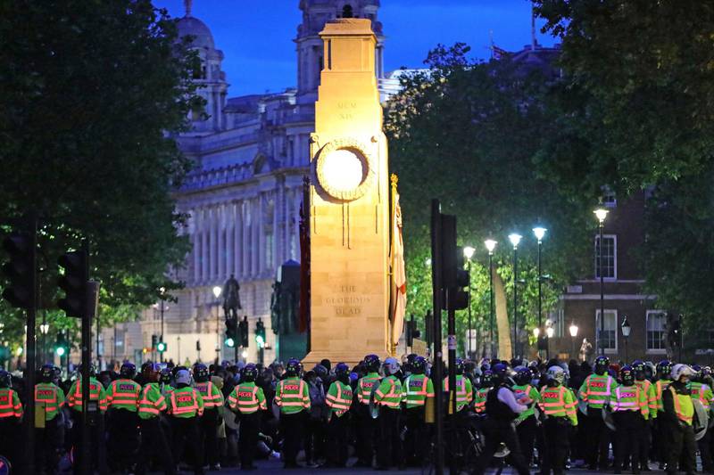 Police officers surround the cenotaph in Whitehall, London, during a Black Lives Matter protest rally Sunday June 7, 2020, in memory of George Floyd who was killed on May 25 while in police custody in the US city of Minneapolis.  (Aaron Chown/PA Wire via AP)