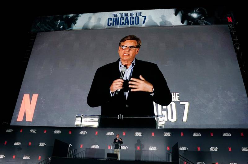 FILE - Aaron Sorkin, writer/director of "The Trial of the Chicago 7," appears on the movie screen as he introduces the film at its drive-in premiere in Pasadena, Calif. on Oct. 13, 2020. (AP Photo/Chris Pizzello, File)