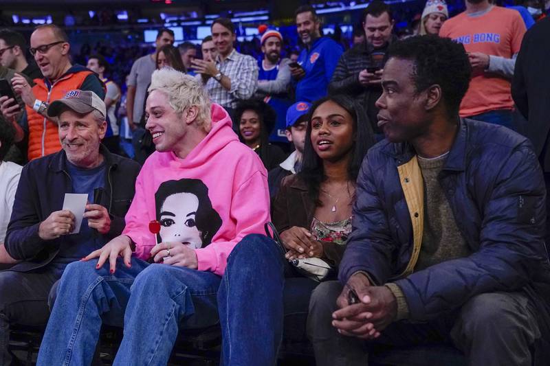 Comedians Jon Stewart, Pete Davidson and Chris Rock sit courtside at an NBA game between the New York Knicks and the Golden State Warriors. AP