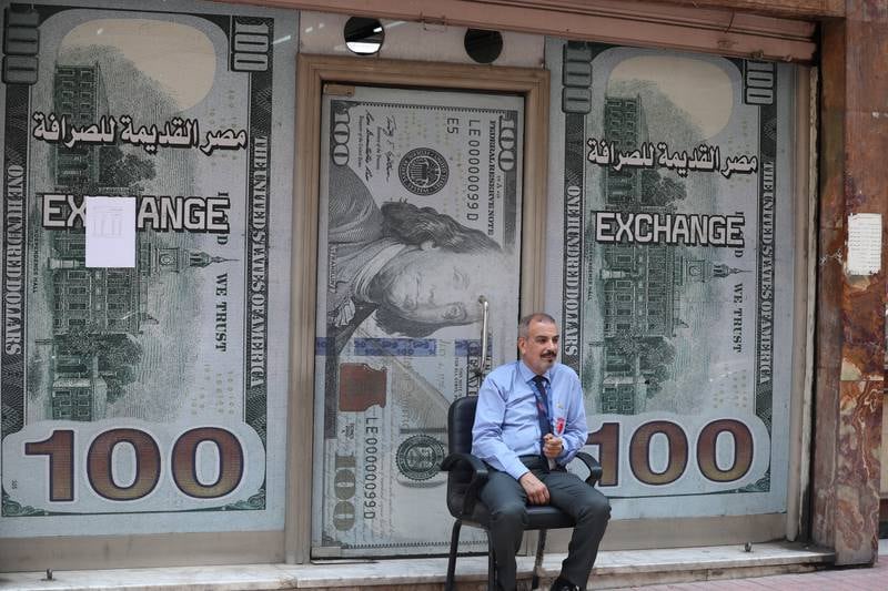 A security guard outside a currency exchange office in Cairo. EPA