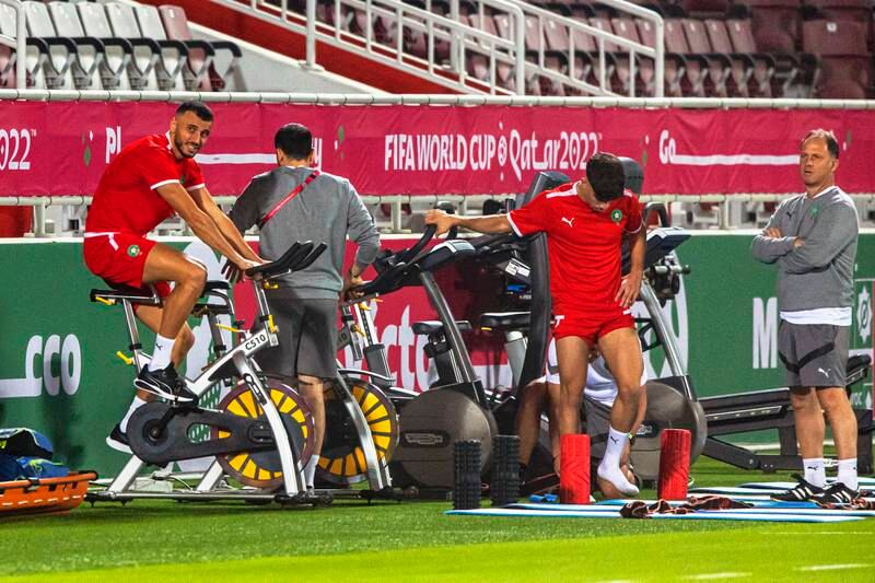 Players warm up for the team's training session in Doha. EPA
