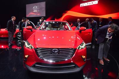 Mazda's new 2016 CX3 attracts attention while on display at the LA Auto Show. Frederic Brown / AFP



