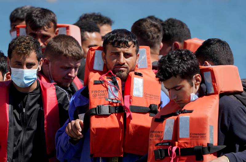 A group of people thought to be migrants are brought to Dover, Kent, on board a Border Force vessel. PA