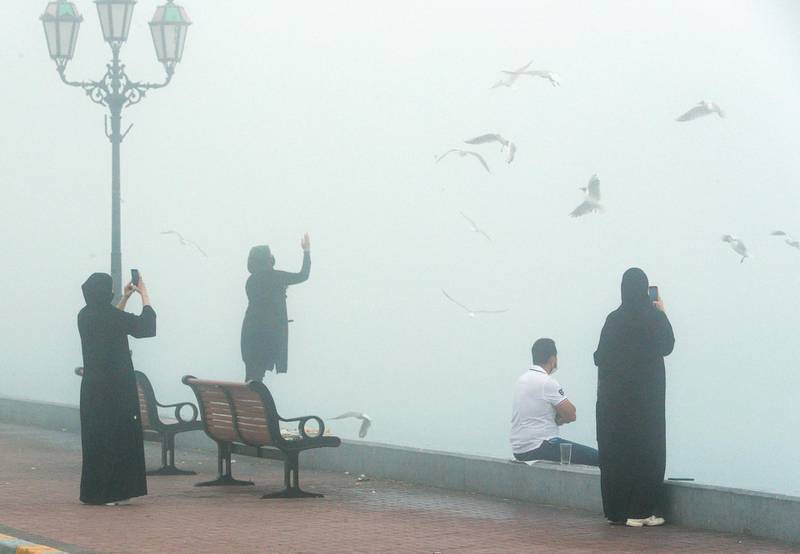 Abu Dhabi, United Arab Emirates, February 16, 2021. Residents enjoy the foggy weather at the UAE Flag area, Corniche.Victor Besa/The NationalSection:  NA/Weather/Big Picture