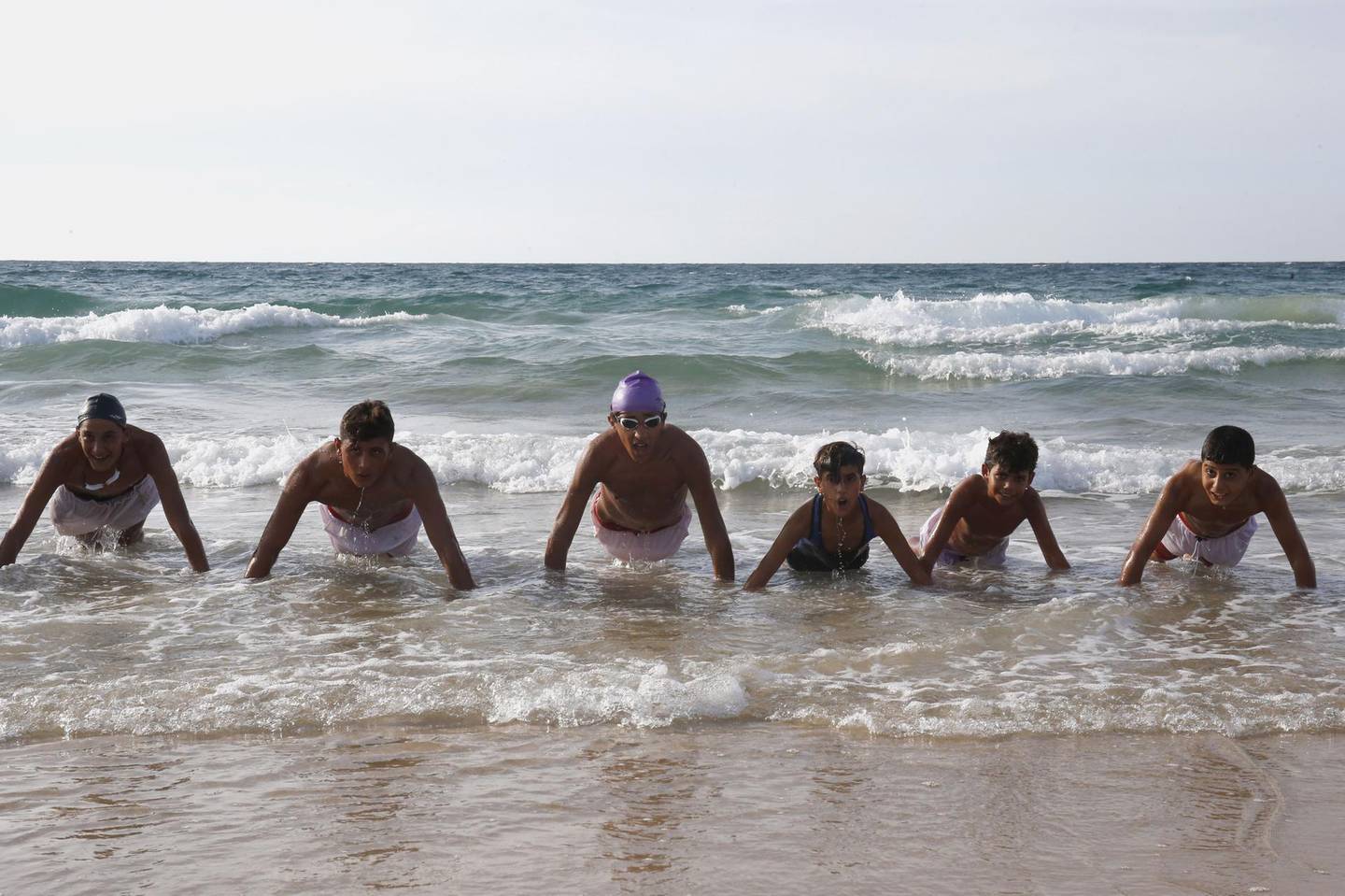 Palestinian children, members of a swimming club, participate in a training session in Beit Lahia in the northern Gaza Strip, on October 4, 2018. On one of the world's most polluted beaches, 30 young Palestinians dive head first into the sea off the coast of Gaza, their minds filled with dreams of Olympic glory. 
Aged between 11 and 16, they make up a rare swimming club in the Gaza Strip, and perhaps its only mixed-sex one.
 / AFP / SAID KHATIB
