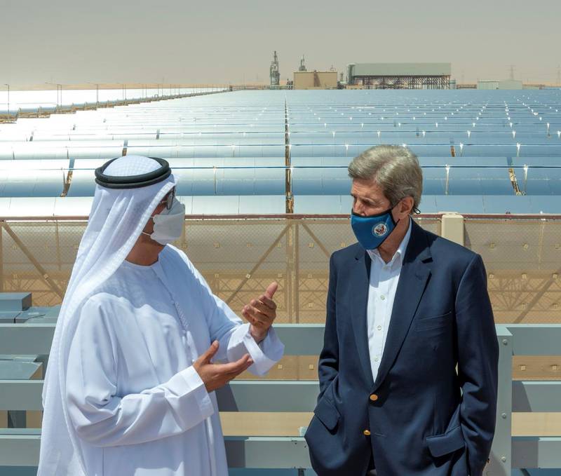 John Kerry speaks with Dr Sultan Al Jaber at Abu Dhabi's Shams 1 solar park on Saturday. The National
